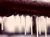 Ice hanging off a frozen pipe